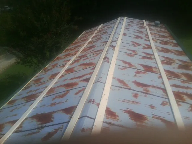 Rusted metal roof panels with new wood purlins before replacement — Storm Damage Roof Repair in Nineveh by Roofing Brothers