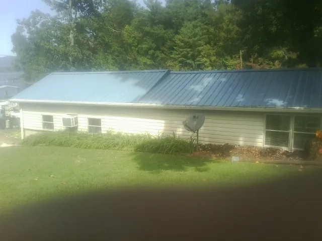 Blue metal roof running the length of a single story home in Nineveh